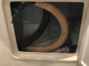 The toilet discharge hose going to the "Y" valve under the sink.....note the curve and how stiff the hose has become in 14 years!
