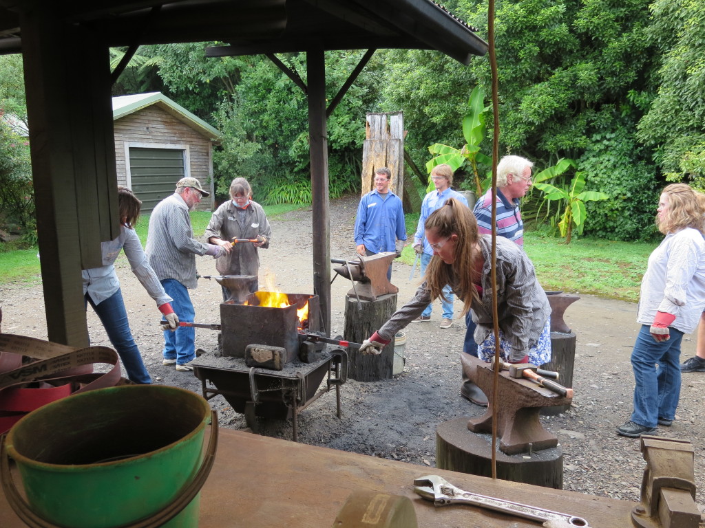 The knifemaking class pounding the steel