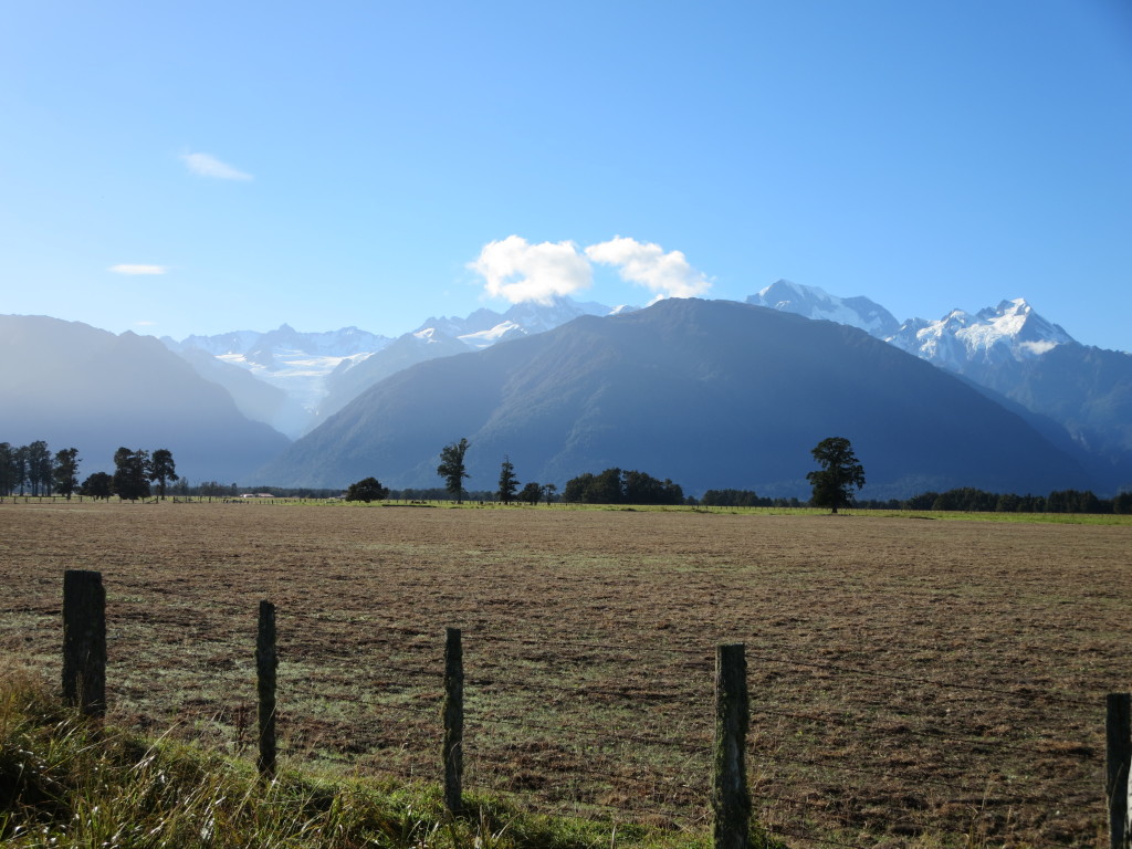 That is the Fox Glacier on the left, Mt Tasman in the middle with the cloud and Mount Cook on the right (we think it includes both peaks)