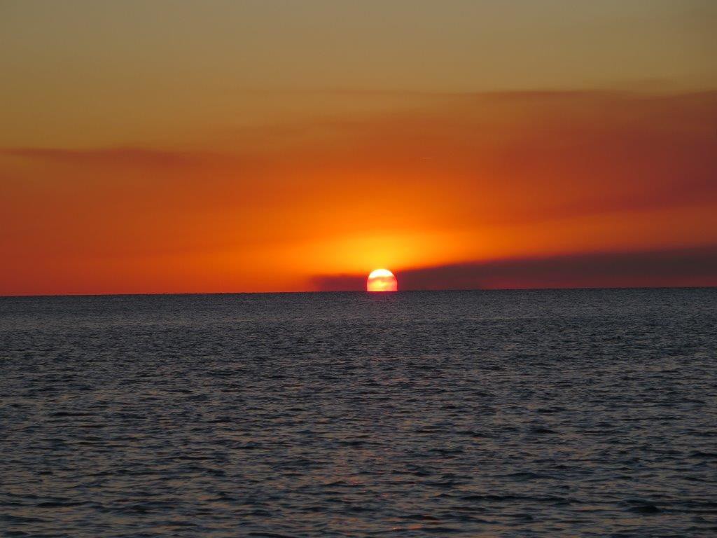 Sunset from Platypus Bay: note the smoke in the air from burning all the sugar cane fields; we are about 40 mile away!!