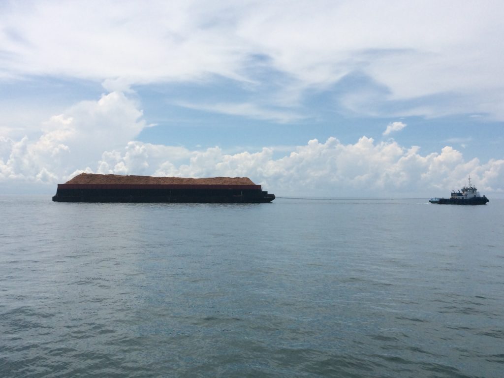 A large barge carry bark and/or sawdust